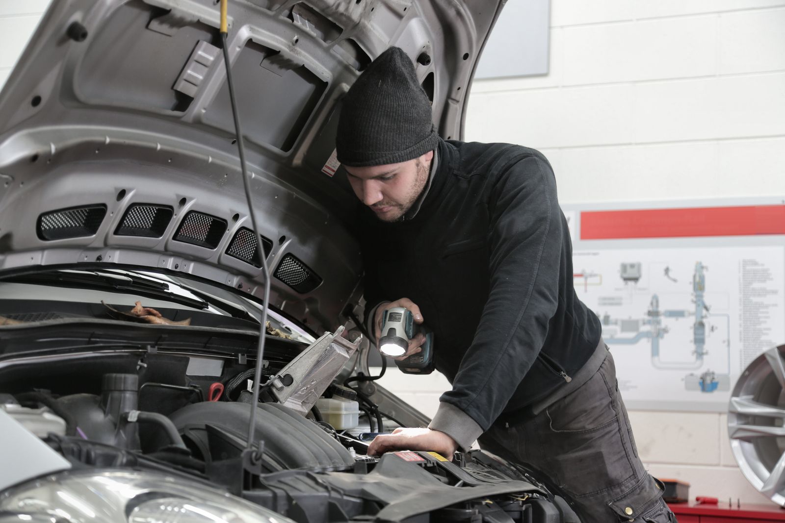 Mechanic inspecting a vehicle in the VAFMC repair shop